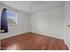 A bedroom with wood flooring, a window, and white walls at 303 N Watauga Ave, Dunn, NC 28334