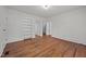 Bright bedroom with hardwood floors, white walls, built-in shelves, and a view of the backyard at 303 N Watauga Ave, Dunn, NC 28334