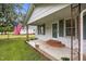 Cozy front porch with brick steps and an American flag, perfect for relaxing outdoors at 303 N Watauga Ave, Dunn, NC 28334