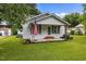 Inviting single-story home with a well-maintained lawn and patriotic American flag at 303 N Watauga Ave, Dunn, NC 28334