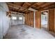 Spacious unfinished garage with exposed wood beam ceiling and concrete floor at 303 N Watauga Ave, Dunn, NC 28334