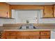 A stainless steel kitchen sink is nestled into a light colored wooden countertop with matching cabinetry at 303 N Watauga Ave, Dunn, NC 28334