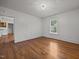 This living room features refinished hardwood floors, white walls, and a large window at 303 N Watauga Ave, Dunn, NC 28334