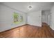 Sunlit living room with hardwood floors, wainscotting, and a large window at 303 N Watauga Ave, Dunn, NC 28334