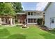Spacious backyard featuring a fire pit, covered patio, and attached sunroom, ideal for outdoor entertaining at 325 Northfield Dr, Raleigh, NC 27609