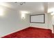 Finished basement featuring plush red carpeting and a built-in projector screen, perfect for a home theater at 325 Northfield Dr, Raleigh, NC 27609