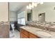 Bathroom featuring dual sinks, granite countertops, and decorative tile at 325 Northfield Dr, Raleigh, NC 27609