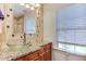 Bathroom featuring granite countertops, glass bowl sink, and tile surround at 325 Northfield Dr, Raleigh, NC 27609