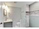 Stylishly updated bathroom with glass-enclosed shower, modern fixtures, and chic gray and white tile at 325 Northfield Dr, Raleigh, NC 27609