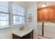 Bright bathroom with a modern vanity, window, and adjacent laundry area at 325 Northfield Dr, Raleigh, NC 27609