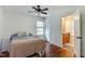 Bedroom with hardwood floors, ceiling fan, and ensuite bathroom at 325 Northfield Dr, Raleigh, NC 27609