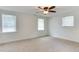 Bright bedroom features neutral carpeting, a ceiling fan, and three windows that allow plenty of natural light at 325 Northfield Dr, Raleigh, NC 27609