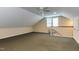 Bonus room features neutral carpeting, dormered ceilings, and a staircase, offering versatility and comfort at 325 Northfield Dr, Raleigh, NC 27609