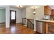 Welcoming entryway featuring hardwood floors, elegant lighting, and stainless steel appliances at 325 Northfield Dr, Raleigh, NC 27609