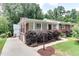 Beautiful home with white siding, brick details, covered porch, and lush landscaping at 325 Northfield Dr, Raleigh, NC 27609
