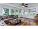 Bright living room featuring large windows, comfortable seating, and hardwood floors at 325 Northfield Dr, Raleigh, NC 27609
