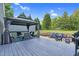 Multi-tiered backyard featuring a covered patio, grilling area, fire pit, and green lawn, ideal for outdoor living at 3713 Highland Creek Dr, Apex, NC 27539