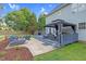 Extensive backyard featuring a patio, deck with grill, covered seating area, fire pit, and large grassy area at 3713 Highland Creek Dr, Apex, NC 27539
