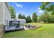 Beautiful backyard featuring a large deck, patio with fire pit, and spacious lawn at 3713 Highland Creek Dr, Apex, NC 27539