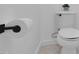 Clean white toilet and matte black toilet paper holder on wall at 3713 Highland Creek Dr, Apex, NC 27539