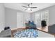 Cozy bedroom featuring a ceiling fan, hardwood floors, and a comfortable chair at 3713 Highland Creek Dr, Apex, NC 27539