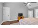 This bedroom features hardwood floors, a ceiling fan, two closets and a tv at 3713 Highland Creek Dr, Apex, NC 27539