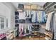 Organized walk-in closet with shelves, hanging rods, and hardwood floors at 3713 Highland Creek Dr, Apex, NC 27539