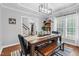 Inviting dining room with bench seating, stylish decor, and a view into the next room at 3713 Highland Creek Dr, Apex, NC 27539