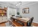 Bright dining room features modern lighting, wood table with bench, and stylish decor at 3713 Highland Creek Dr, Apex, NC 27539