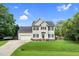 Charming two-story home with blue shutters, an attached garage, and well-manicured lawn with an American flag at 3713 Highland Creek Dr, Apex, NC 27539