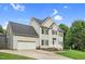 Side angle of a two-story home featuring an attached garage, blue shutters, well-kept lawn, and landscaping at 3713 Highland Creek Dr, Apex, NC 27539