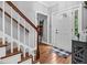 Welcoming foyer featuring hardwood floors, stairs, and a front door with a window, plus entry rug at 3713 Highland Creek Dr, Apex, NC 27539