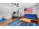 A workout area including a treadmill, exercise bike, ceiling fan, and futon at 3713 Highland Creek Dr, Apex, NC 27539