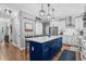 Stylish kitchen with a spacious island, stainless steel appliances, and adjacent pantry at 3713 Highland Creek Dr, Apex, NC 27539