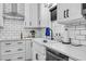 Bright kitchen with a white farmhouse sink, subway tile backsplash, and stainless steel dishwasher at 3713 Highland Creek Dr, Apex, NC 27539