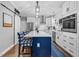 Modern kitchen with large island, stainless steel appliances, and pantry door at 3713 Highland Creek Dr, Apex, NC 27539