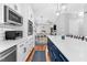 Modern kitchen featuring stainless steel appliances, subway tile backsplash, and an eat-in island at 3713 Highland Creek Dr, Apex, NC 27539