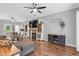Open-concept living area features a fireplace, built-in shelves, and hardwood flooring at 3713 Highland Creek Dr, Apex, NC 27539