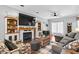 Inviting living room featuring a cozy fireplace, built-in shelves, and comfortable seating at 3713 Highland Creek Dr, Apex, NC 27539