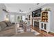Comfortable living room with a fireplace, built-in shelves, and cozy seating arrangements at 3713 Highland Creek Dr, Apex, NC 27539