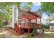 A wooden deck and pergola overlook a beautiful backyard and the woods at 425 Hidden Cellars Dr, Holly Springs, NC 27540