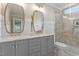 Modern bathroom features double vanity, a glass-enclosed shower and decorative mirrors at 425 Hidden Cellars Dr, Holly Springs, NC 27540