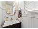 The bathroom includes a dark vanity and a decorative, gold trimmed mirror at 425 Hidden Cellars Dr, Holly Springs, NC 27540