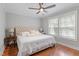 Comfortable bedroom with natural light features hardwood floors and a ceiling fan at 425 Hidden Cellars Dr, Holly Springs, NC 27540
