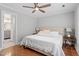 Bright bedroom with natural light features hardwood floors and modern ceiling fan at 425 Hidden Cellars Dr, Holly Springs, NC 27540