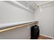 Walk in closet with built-in shelving and a suitcase on the hardwood floor at 425 Hidden Cellars Dr, Holly Springs, NC 27540