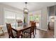 Cozy dining room with a wood table, natural light, and access to the outdoor patio at 425 Hidden Cellars Dr, Holly Springs, NC 27540