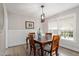 Dining room with a wooden table, chairs, large windows and decorative wainscoting at 425 Hidden Cellars Dr, Holly Springs, NC 27540