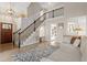 Spacious entryway with stairs, wooden floors, and open view into the laundry area at 425 Hidden Cellars Dr, Holly Springs, NC 27540