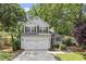 Charming two-story home with a manicured yard, a two-car garage, and front porch at 425 Hidden Cellars Dr, Holly Springs, NC 27540
